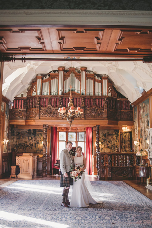 Interior of the ceremony and piano room at Fyvie castle with wedding couple