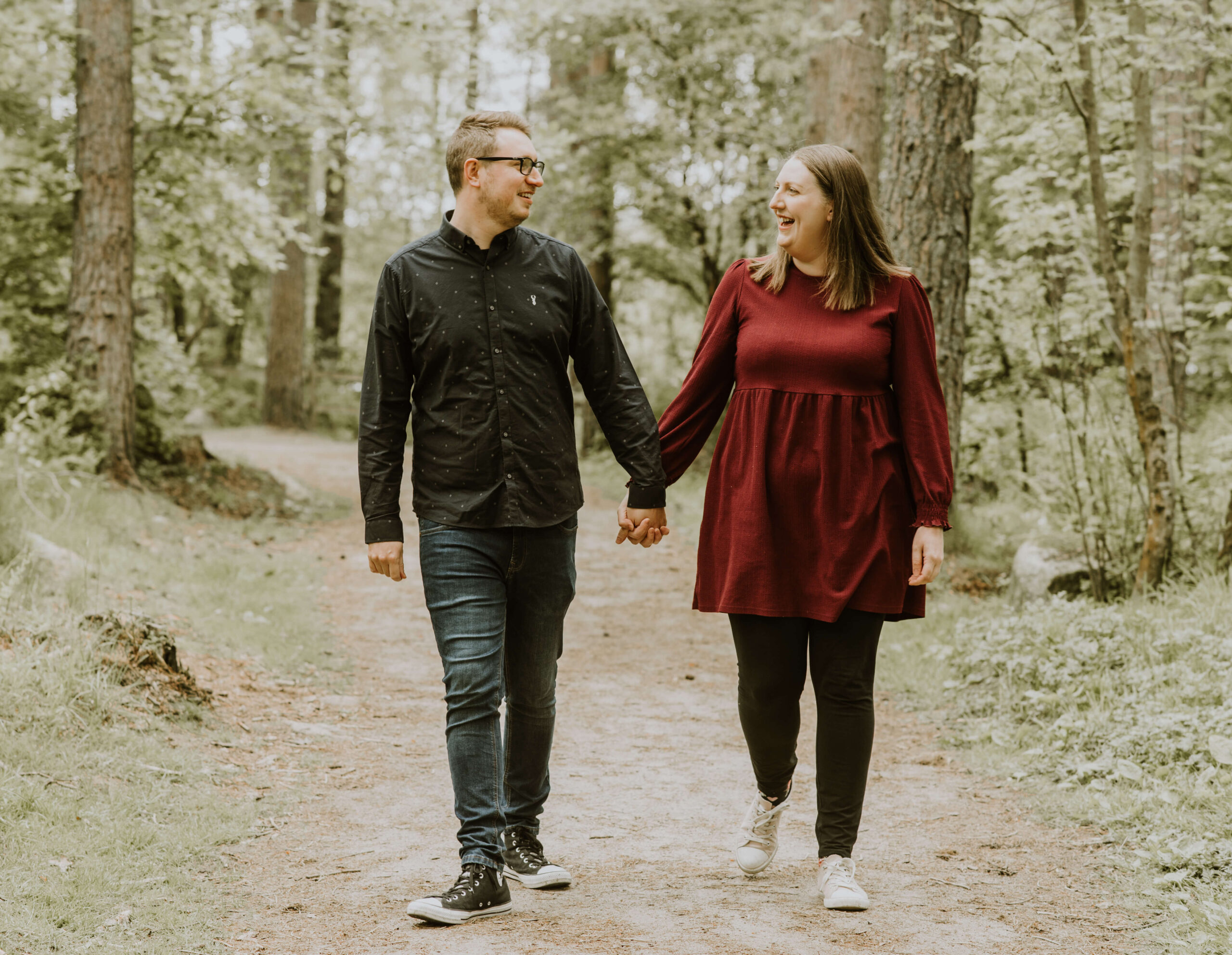 An engaged couple walk in the woods near Bennachie, Aberdeenshire