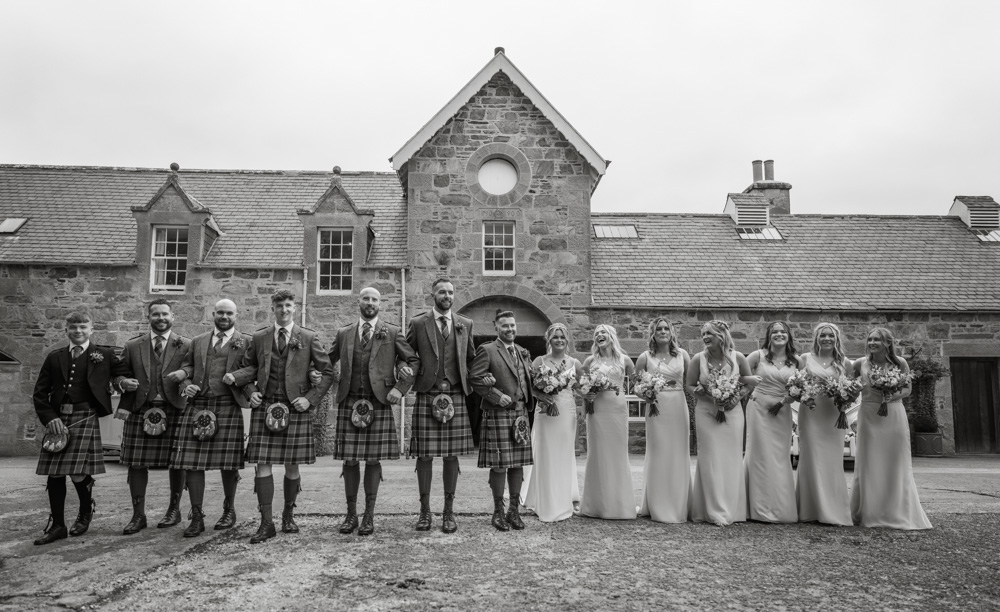 Bridal party gatehr and laugh after Katie and Dan's big day at Aswanley, Huntly, Aberdeenshire