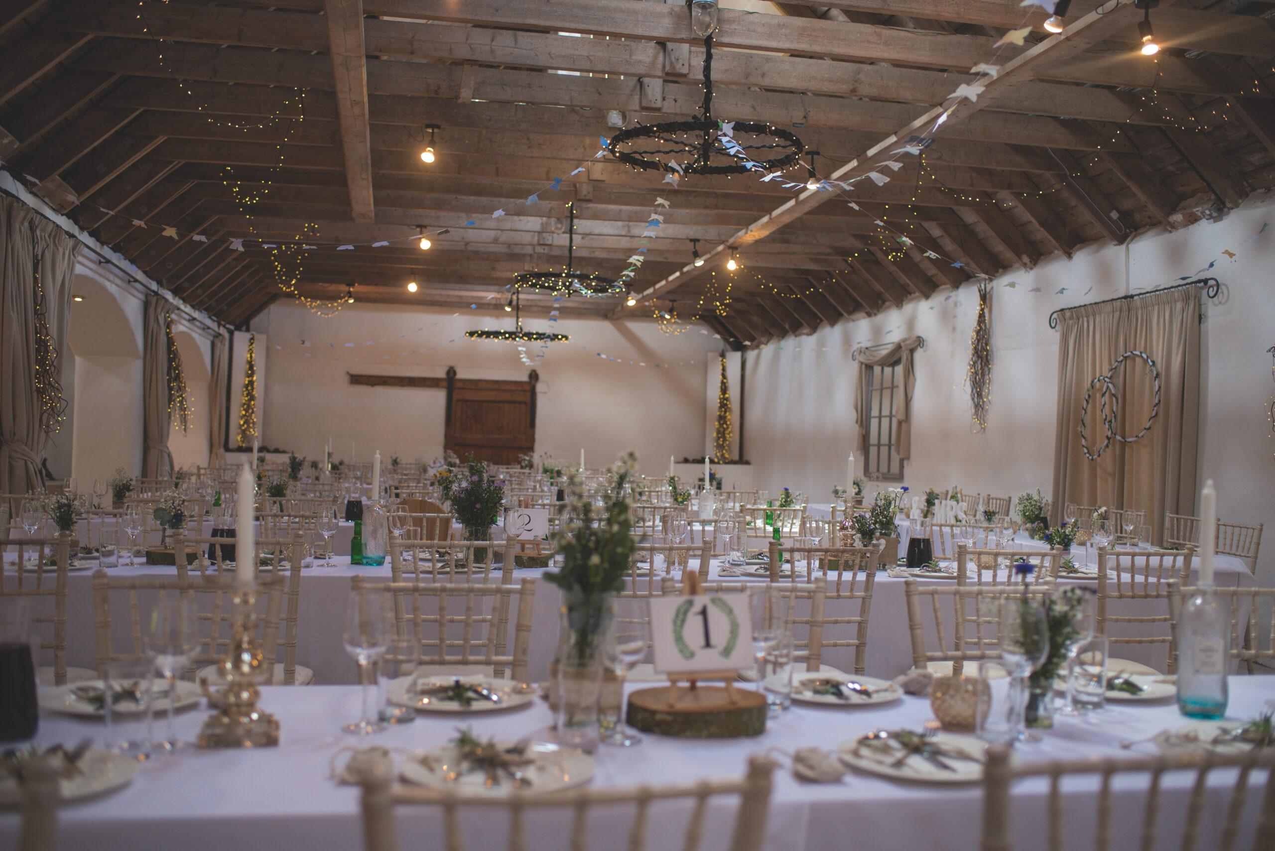 Interior of Aswanley wedding venue with its rustic barn roof taken by Zoe Rae Photography