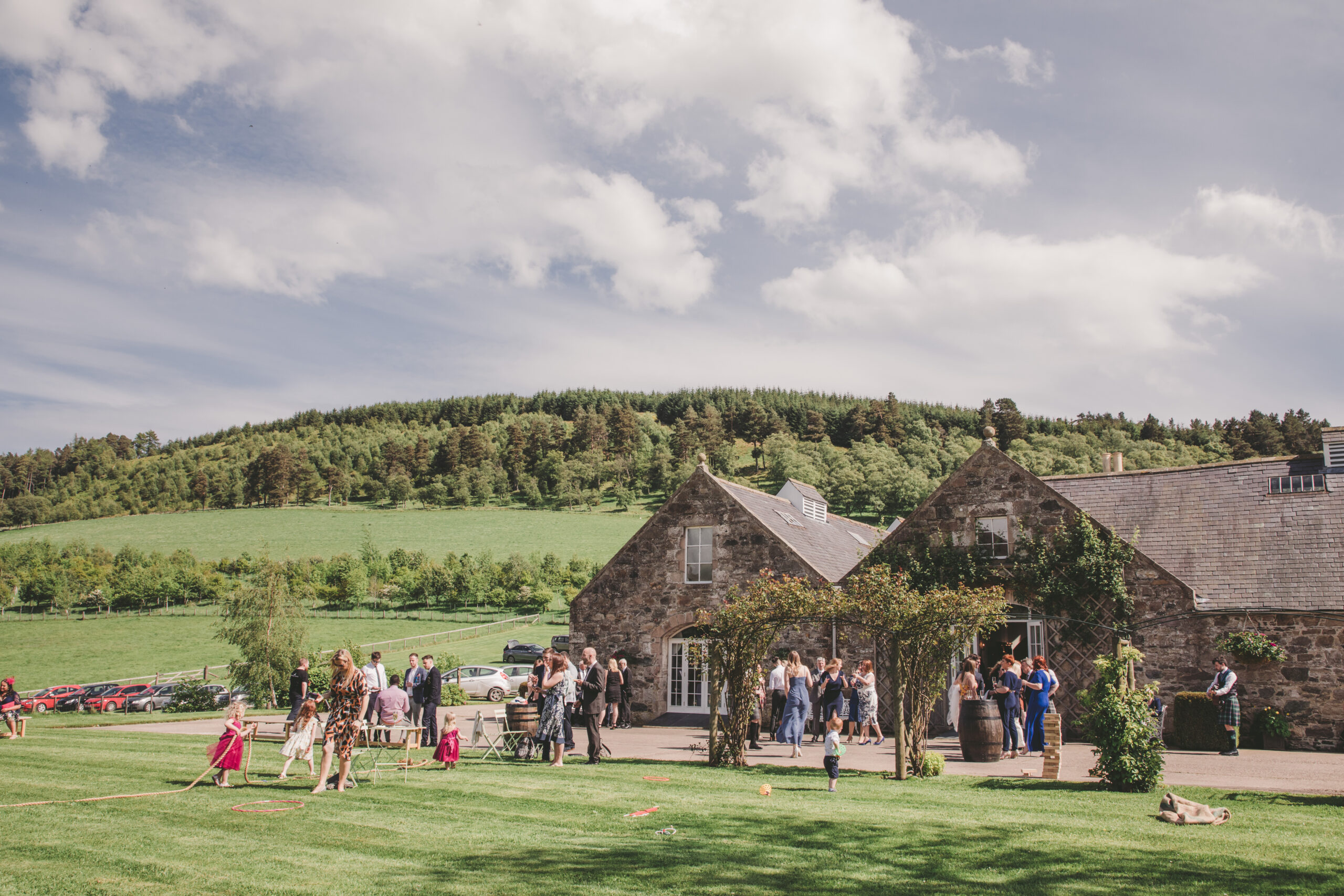 Wedding guests enjoying the sunshine at Aswanley wedding venue on a summers day